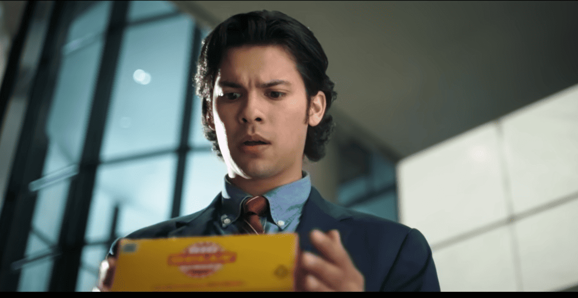 Image of Blue Beetle star holding a package.